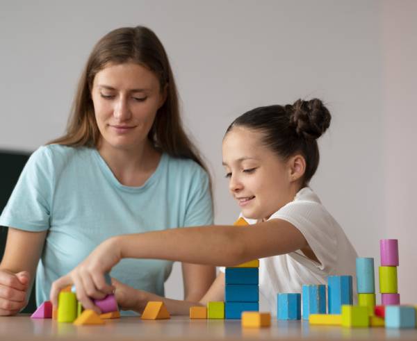 playing with a set of colorful building blocks